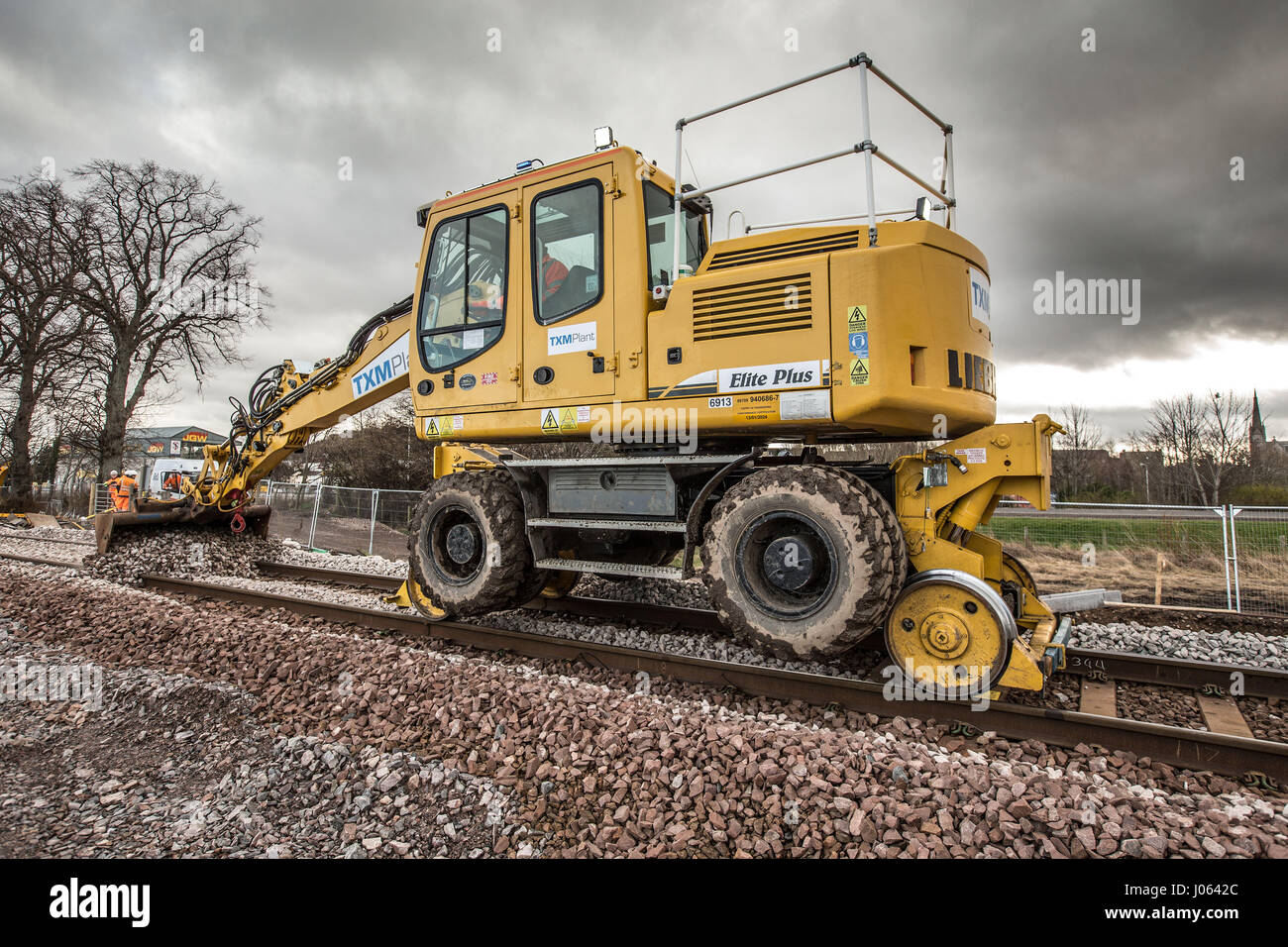 Rail workers spreading ballast and laying new line in Forres Scotland
