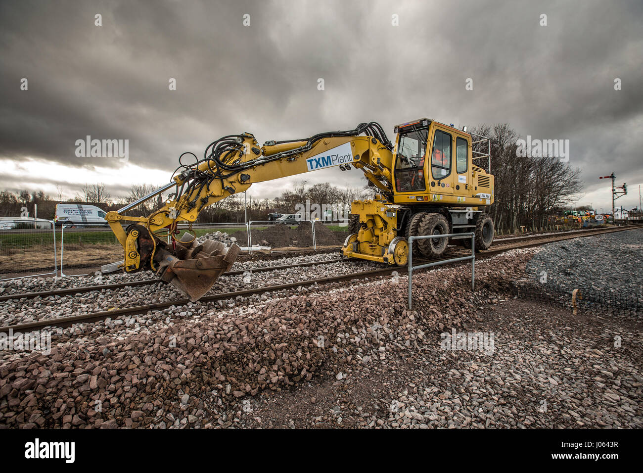 Rail workers spreading ballast and laying new line in Forres Scotland