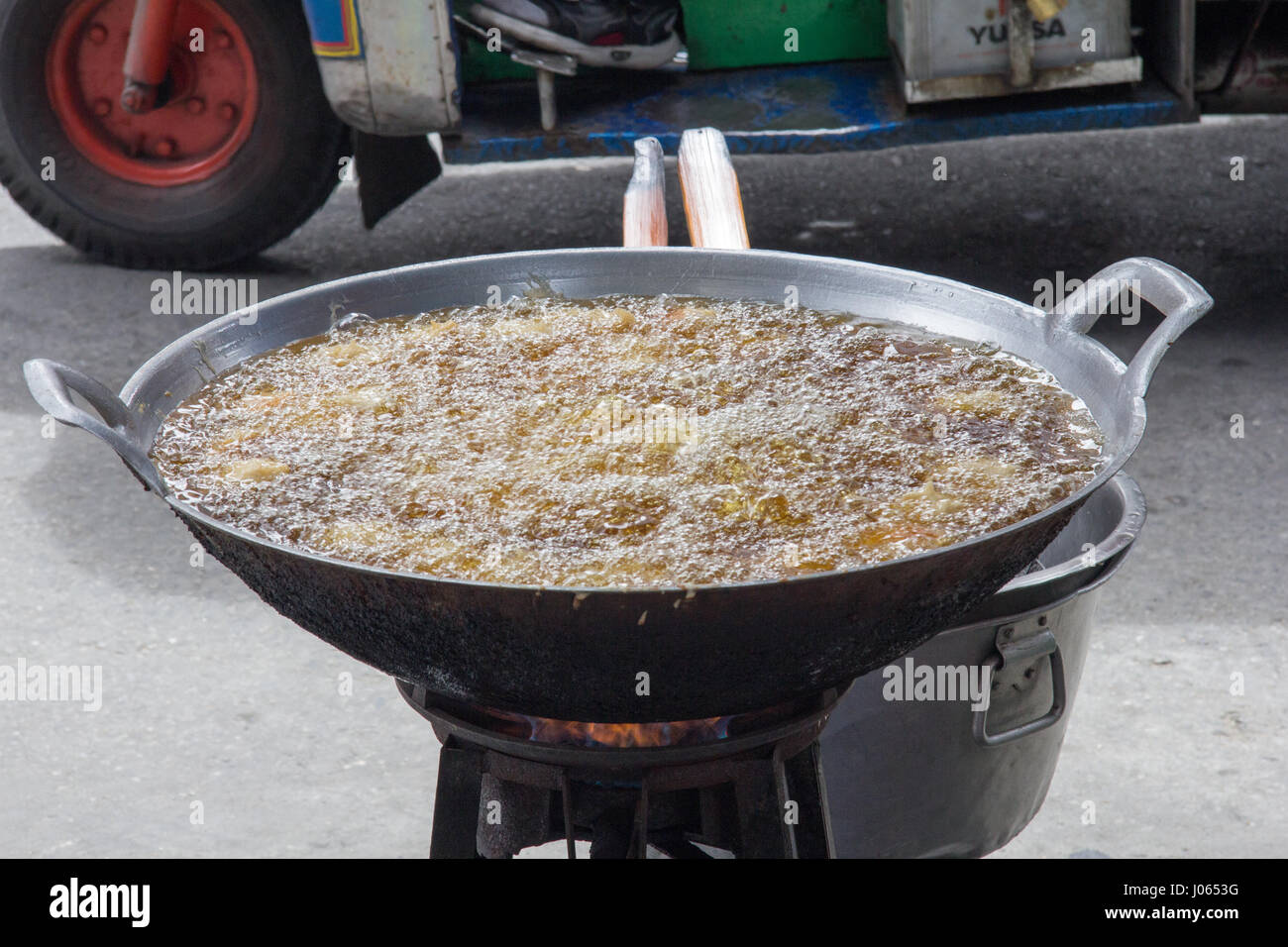 Dangerous pan full of boiling oil on a street in Chinatown, Bangkok, Thailand Stock Photo