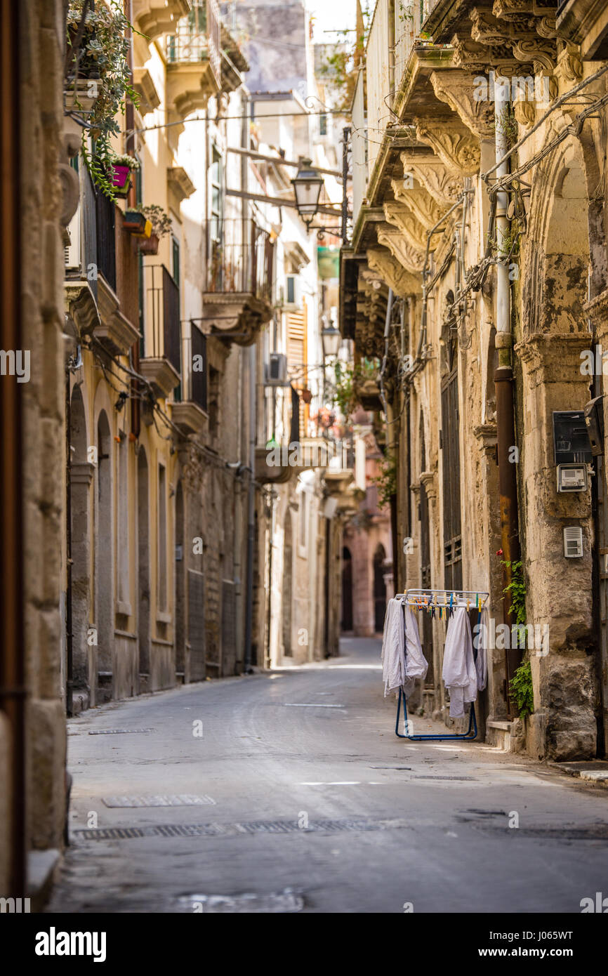 A narrow street in the beautiful old city of Noto in the Province of Siracusa in Sicily, Italy. Stock Photo