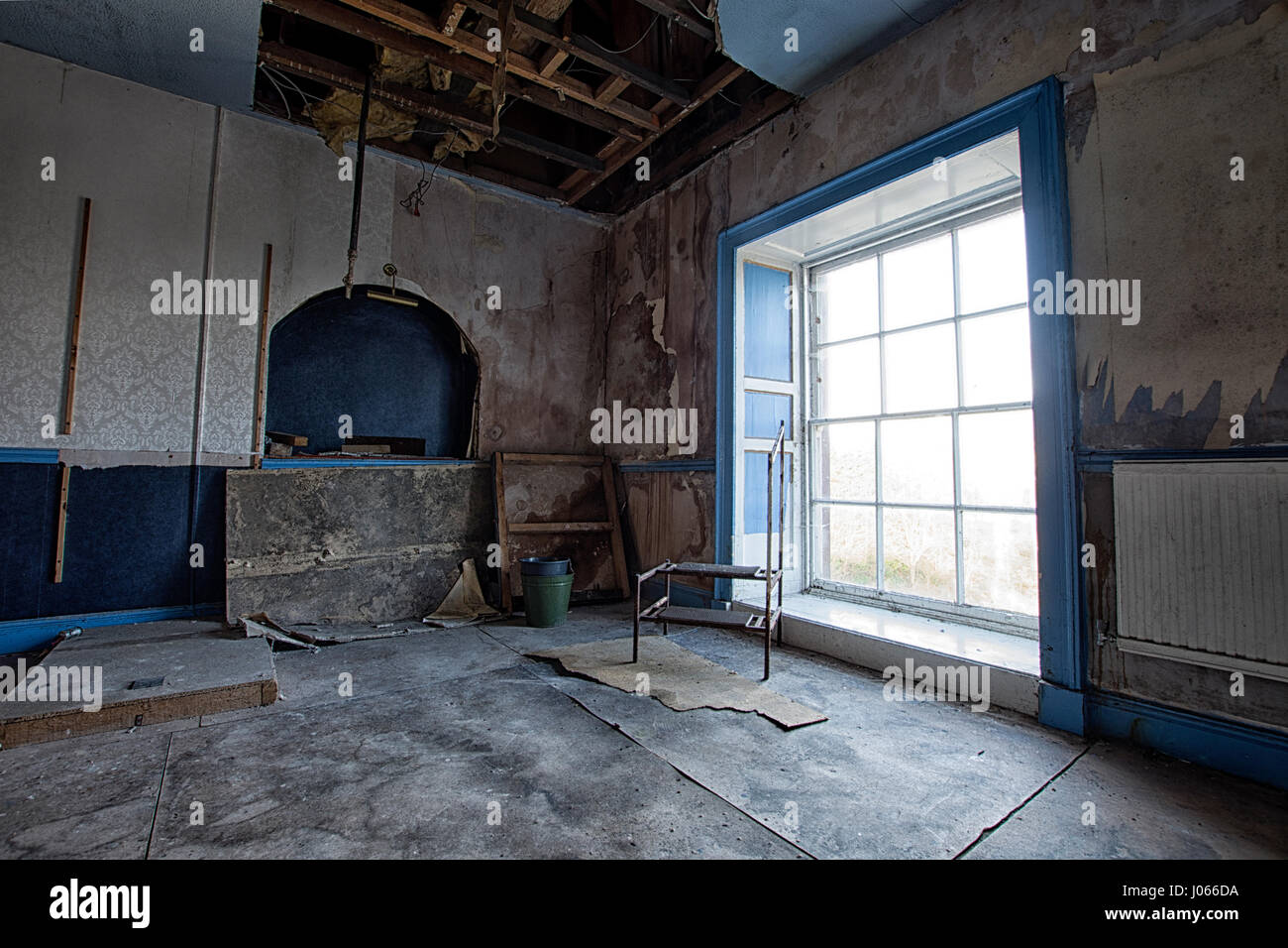 WOOLTON HALL, LIVERPOOL: STUNNING photographs reveals 300-year-old manor house’s doors boarded up and the property abandoned despite it’s role as the HQ of a regiment of D-Day heroes during WW2. Pictures shows a grand manor house windows bricked up and grounds neglected. While some rooms appear to be in good condition, having been only recently abandoned, photos show exposed rotting floorboards, peeling wallpaper and parts of the ceiling falling apart. These haunting images of Woolton Hall in Liverpool were taken by a freelance photographer and urban explorer who wished to remain anonymous. Sh Stock Photo