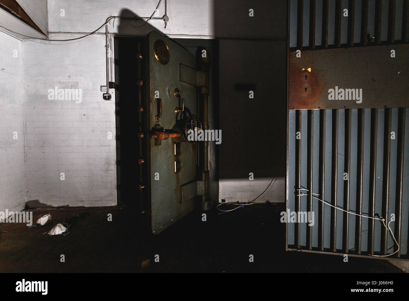 BELFAST, UK: EERIE images have revealed the rotting remains of a once-thriving bank in the heart of a British high street where an Irish rebel leader was once sentenced to death. The unsettling snaps show the bank’s ten-foot high vault as well as rows of safety deposit boxes and one man rifling through them. Other pictures show posters from the early 20th Century championing women’s rights to vote and a Guy Fawkes mask left hanging and dusty log books, all left behind since the place was abandoned in 2000. The stunning shots were taken at an abandoned Northern Bank in Belfast city centre by ph Stock Photo