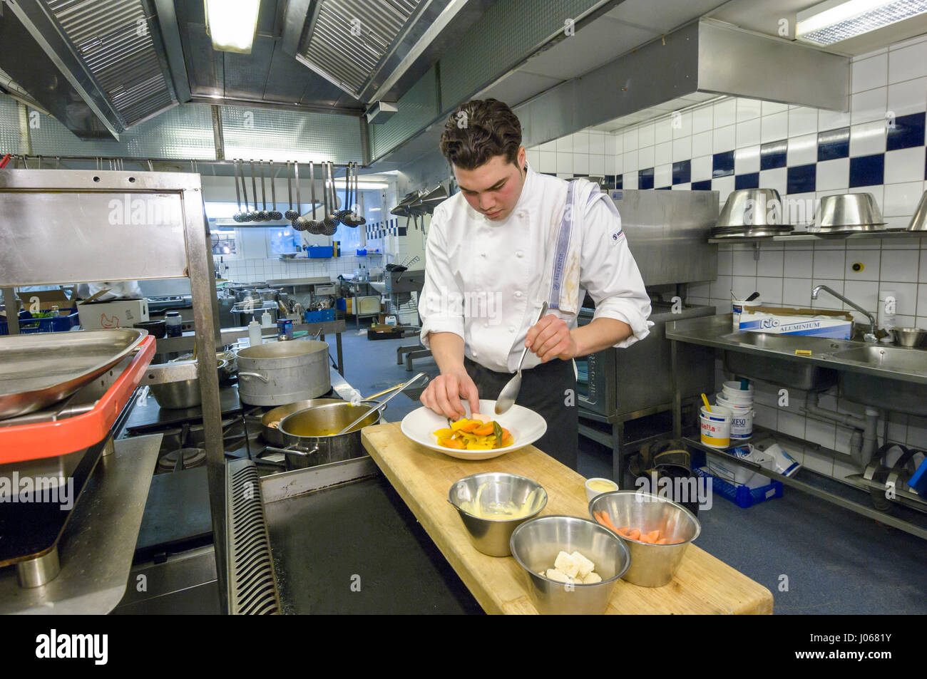 Students in a restaurant school learn to cook, Sweden. Stock Photo