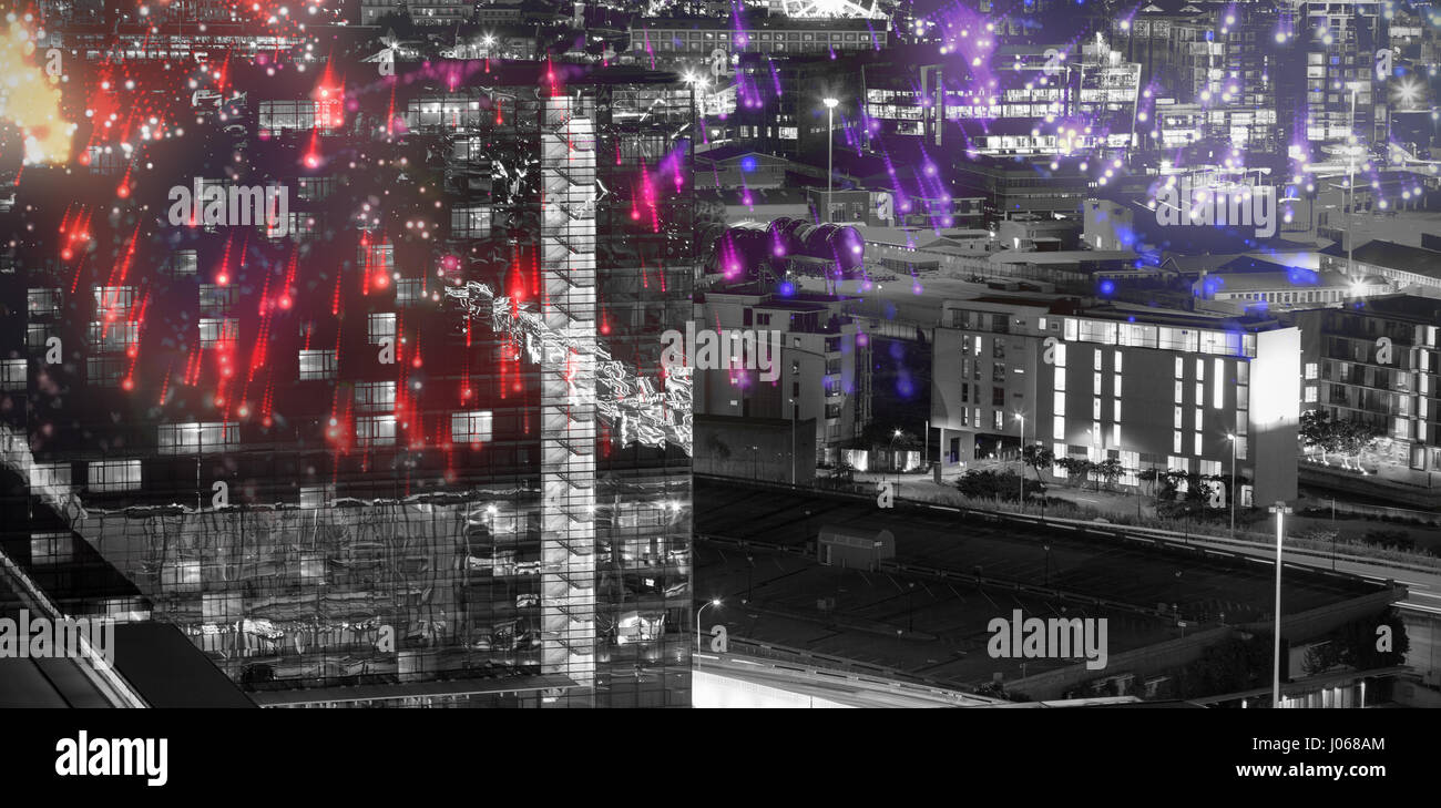 Colourful fireworks exploding on black background against illuminated beautiful buildings in city Stock Photo