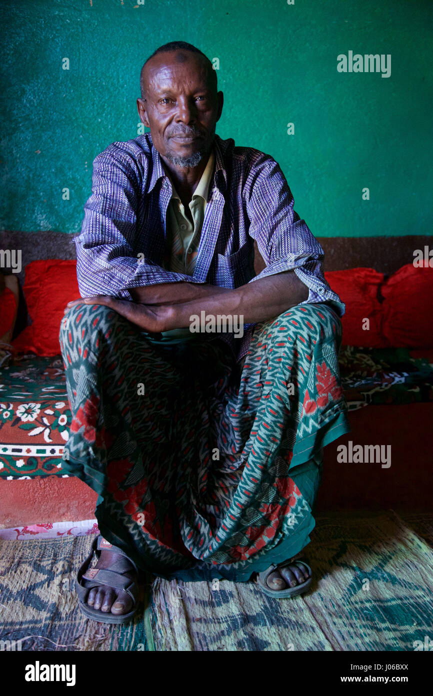 HARAR, ETHIOPIA: Headshot of 'Hyena Man' Yusuf Mume Saleh. MEET the incredible Hyena Man of Harar who is now passing his title onto his son after thirty years of being best friends with a clan of these carnivorous beasts. Pictures show a young heir to the Hyena man title following the centuries-old tradition of protecting his people from possible attack by hyenas by calmly feeding these wild scavengers. He does so completely free from any kind of fear you would associate with being this close to Africa’s most prolific carnivore.  Hyenas have been known to attack and kill humans, but as these r Stock Photo