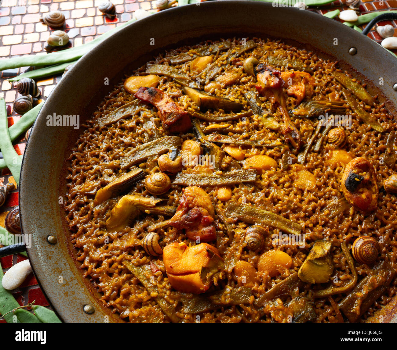 Valencian Paella with chicken rabbit artichokes beans and snails Stock
