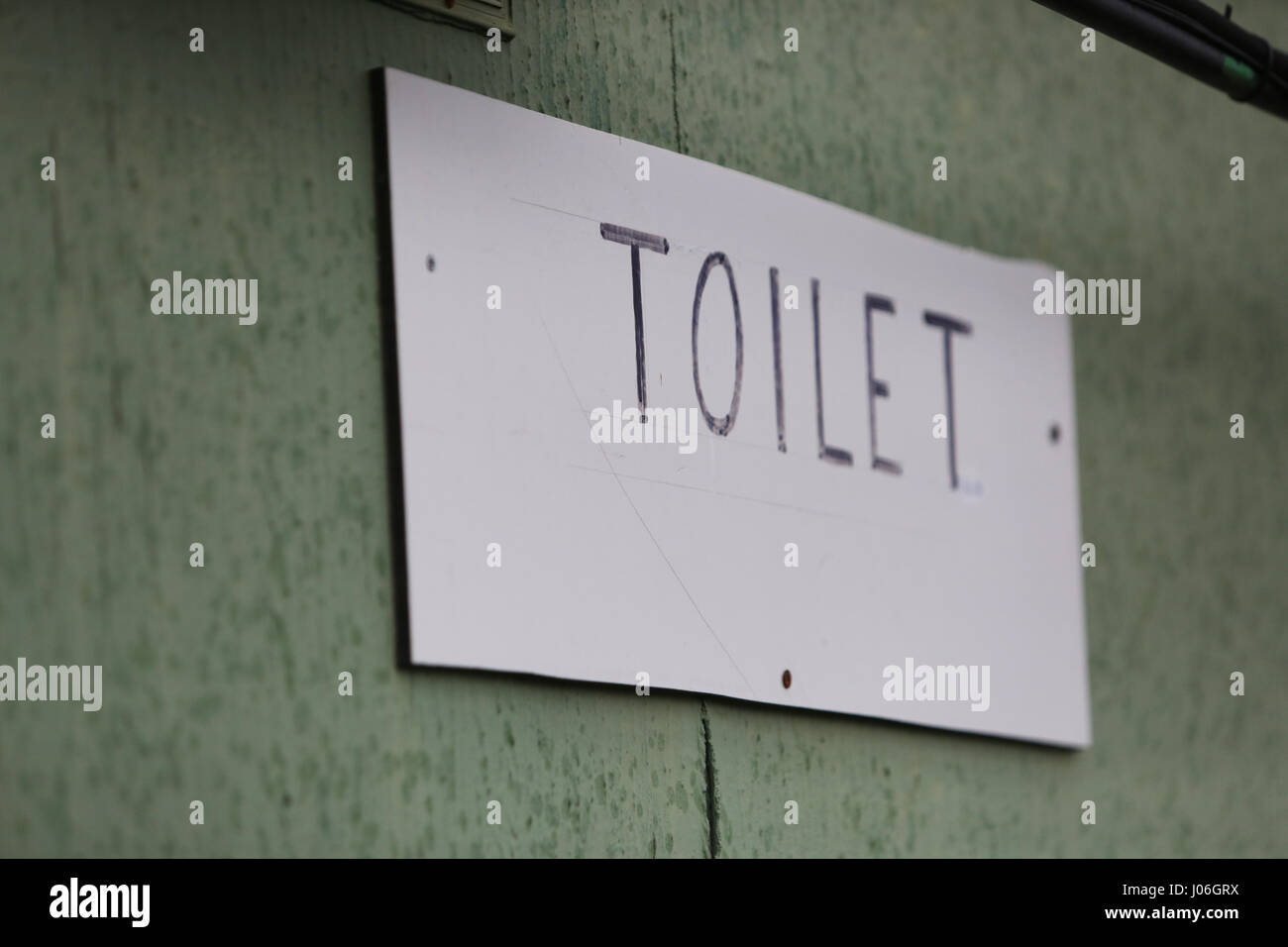 Old toilet sign pictured on the outside of a bathroom, UK. Stock Photo