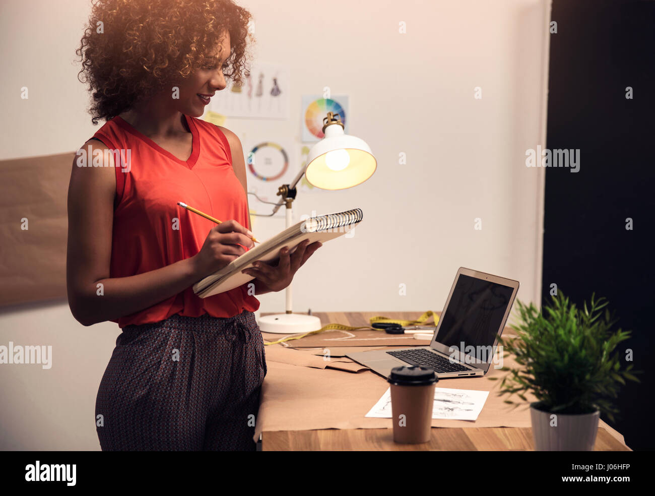 A young fashion designer working on her atelier Stock Photo - Alamy