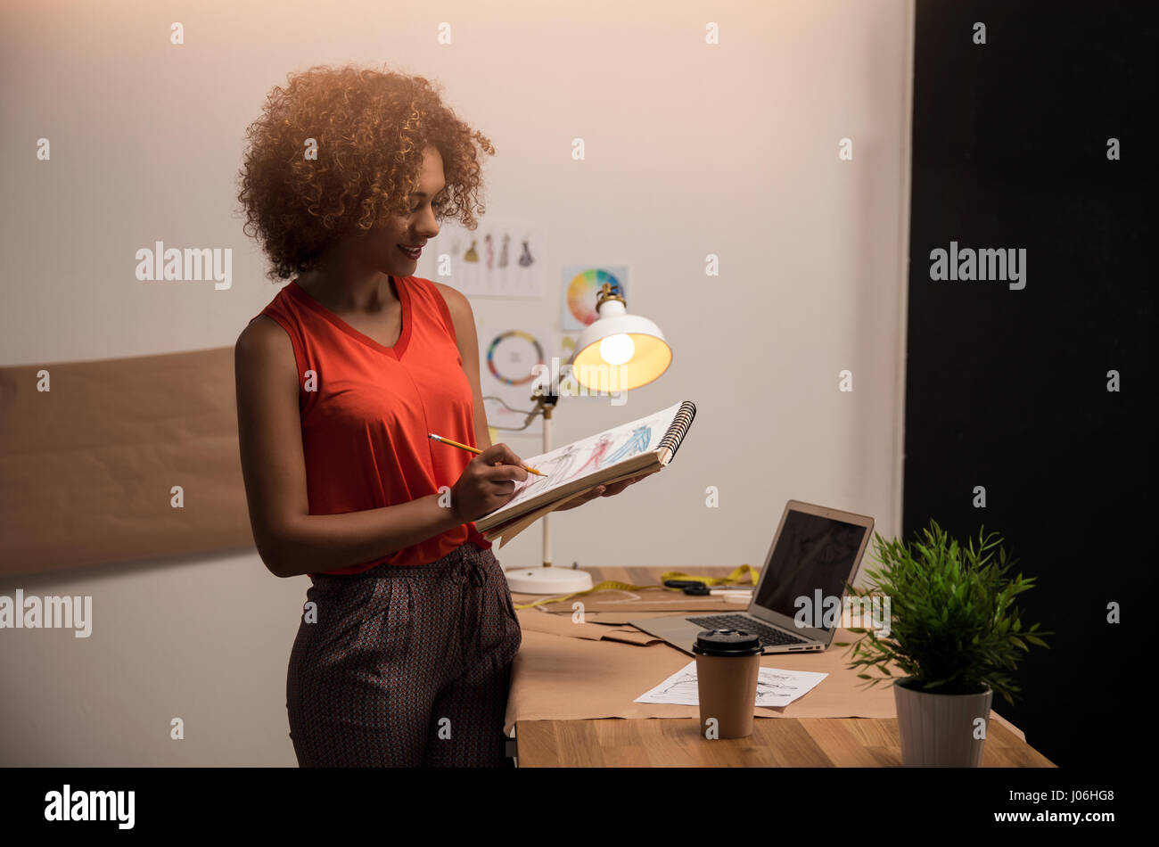 A young fashion designer working on her atelier Stock Photo - Alamy
