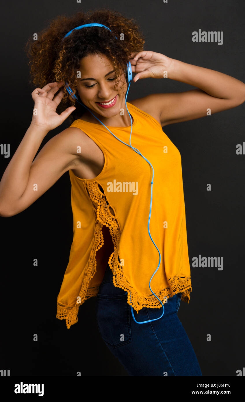 Beautiful African American woman listen  music and dancing Stock Photo