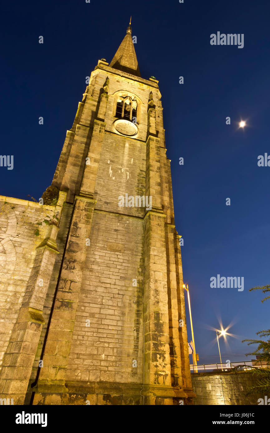 Charles Church in Plymouth , Devon, UK lit in the evening sky with traffic trails whizzing around the outside. Stock Photo