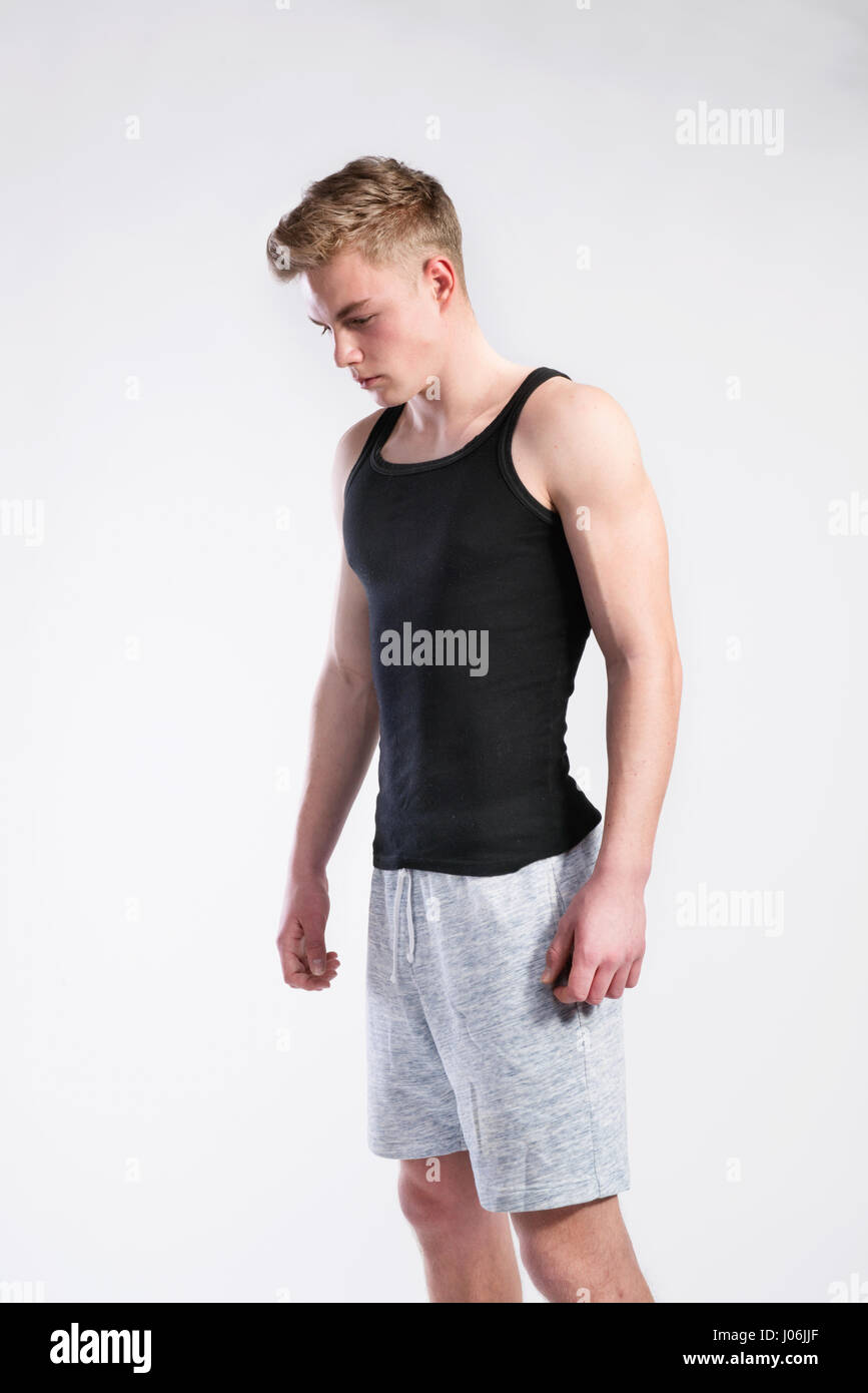Handsome fitness man in black tank top shirt, studio shot Stock Photo