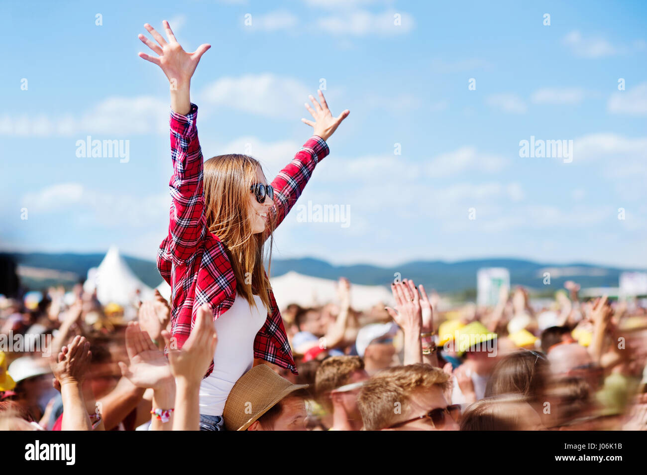 Teenagers at summer music festival enjoying themselves Stock Photo