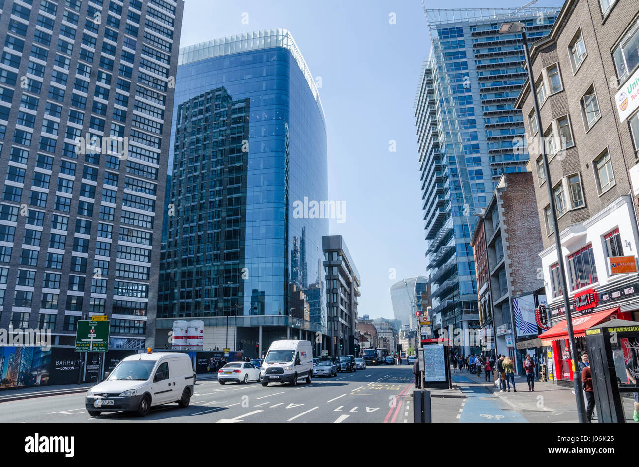 A view down Whitechapel High Street lined with tall, modern buildings