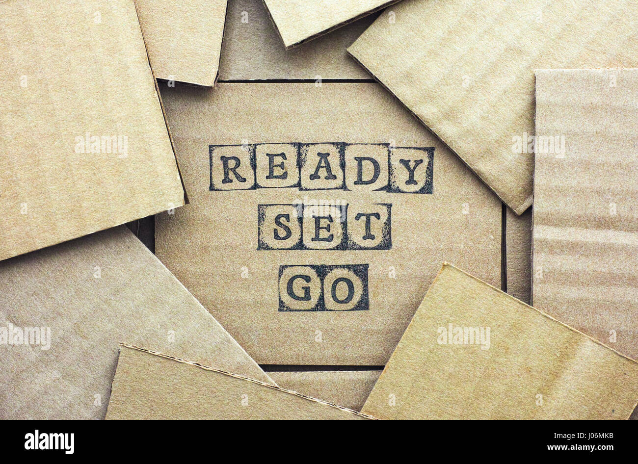 Cardboard card with words Ready Set Go made by black alphabet stamps
