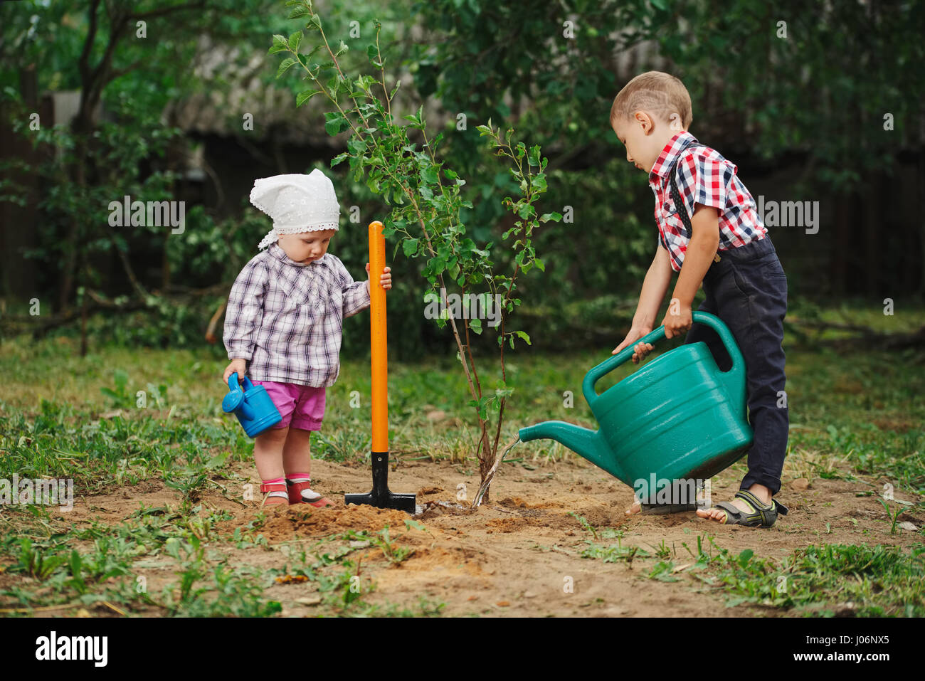 little funny boy with shovel in garden Stock Photo - Alamy