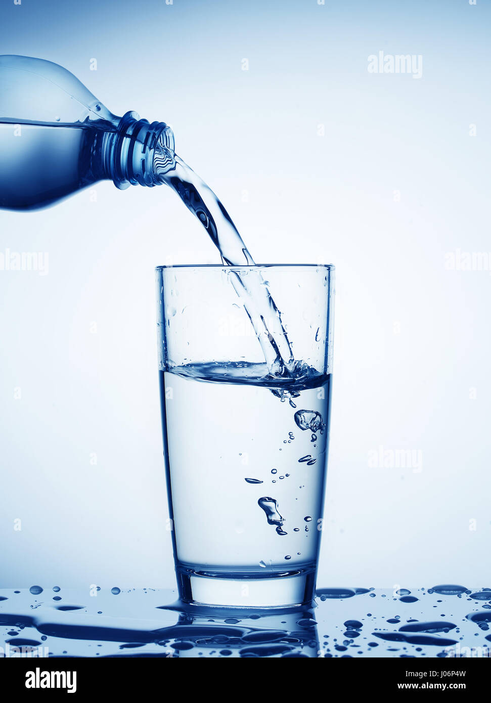 Download Water Flowing From Bottle Into A Glass Toned In Blue Stock Photo Alamy Yellowimages Mockups