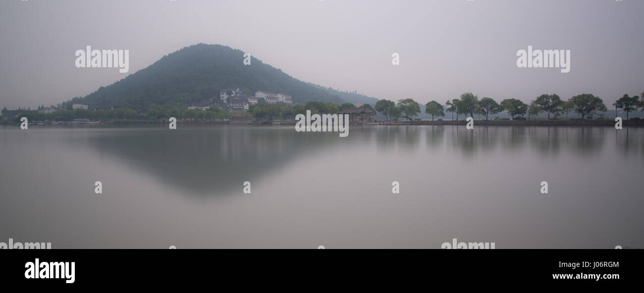 Chinese bridge and pavillon by the lake in daybreak NanBei Lake Zhejiang China Stock Photo