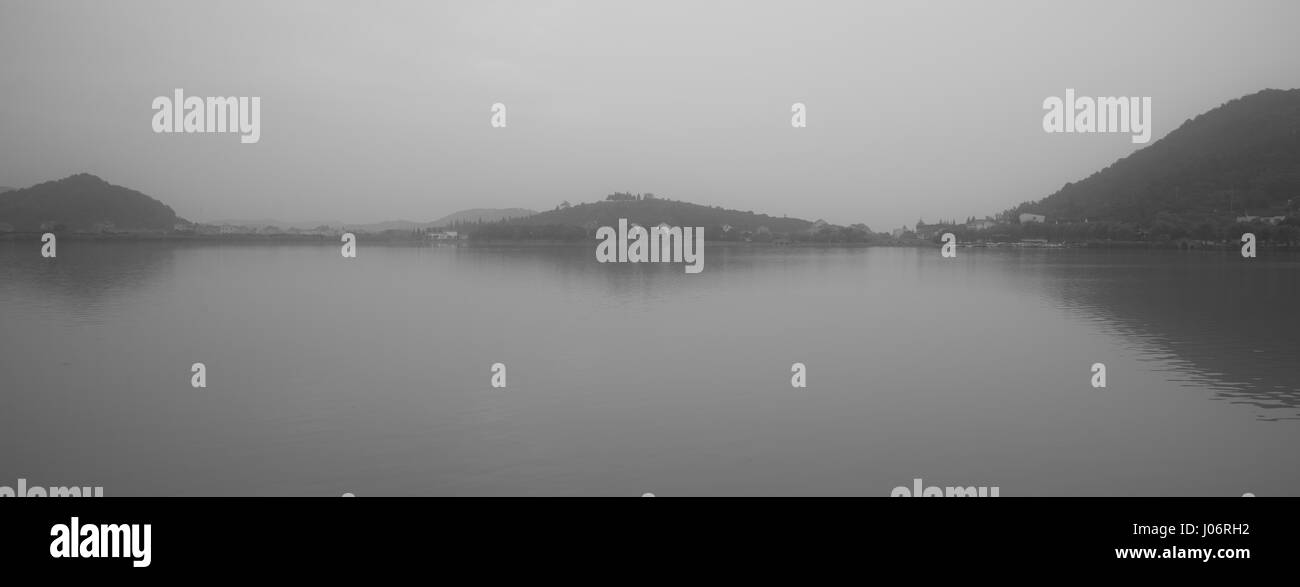 Chinese bridge and pavillon by the lake in daybreak NanBei Lake Zhejiang China Stock Photo