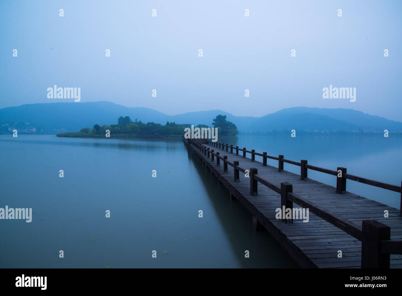 Chinese bridge and pavillon by the lake in daybreak NanBei Lake Zhejiang China Stock Photo