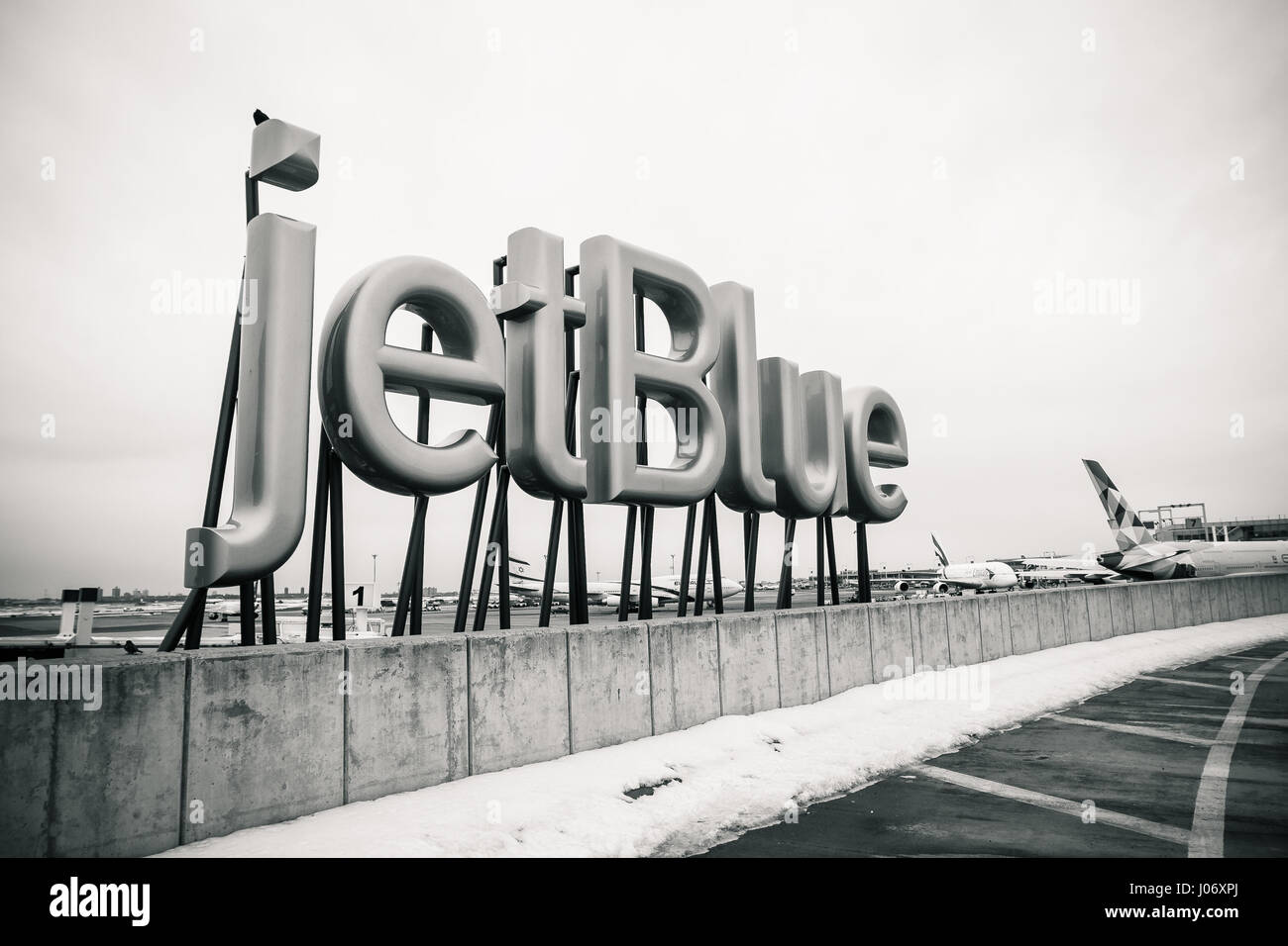 jetBlue sign is displayed near the entrance to the jetBlue terminal of the JFK airport. Stock Photo