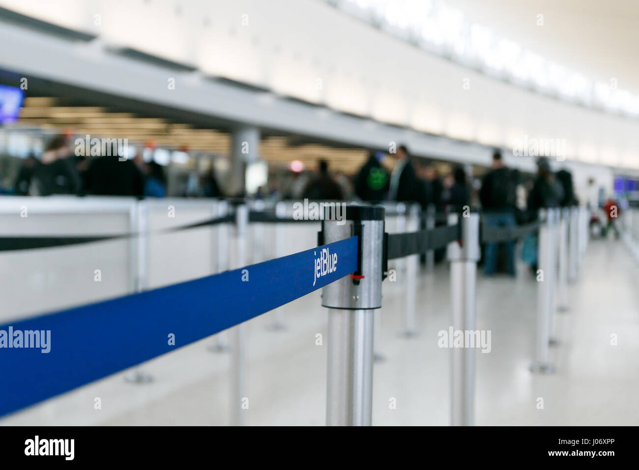 People line up to go through security checkpoint at the jetBlue terminal of the JFK airport. Stock Photo