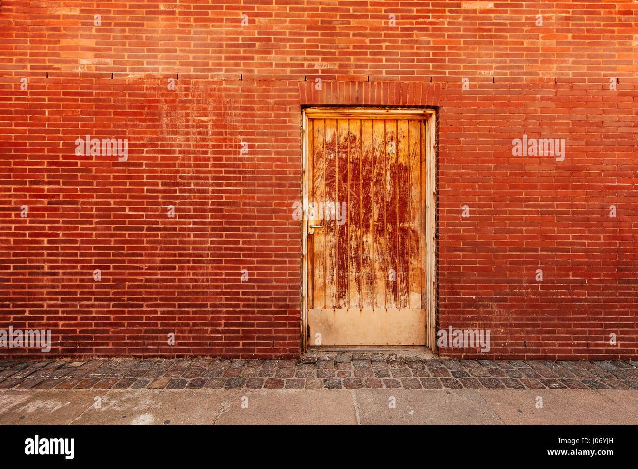 Backdoor, old weathered door and brick wall, backstreet urban detail Stock Photo