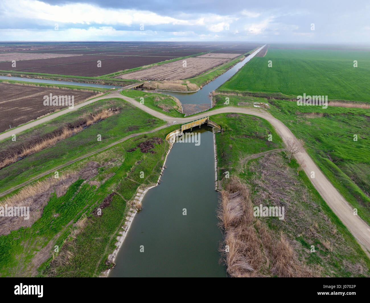 Bridges through irrigation canals. Rice field irrigation system Stock