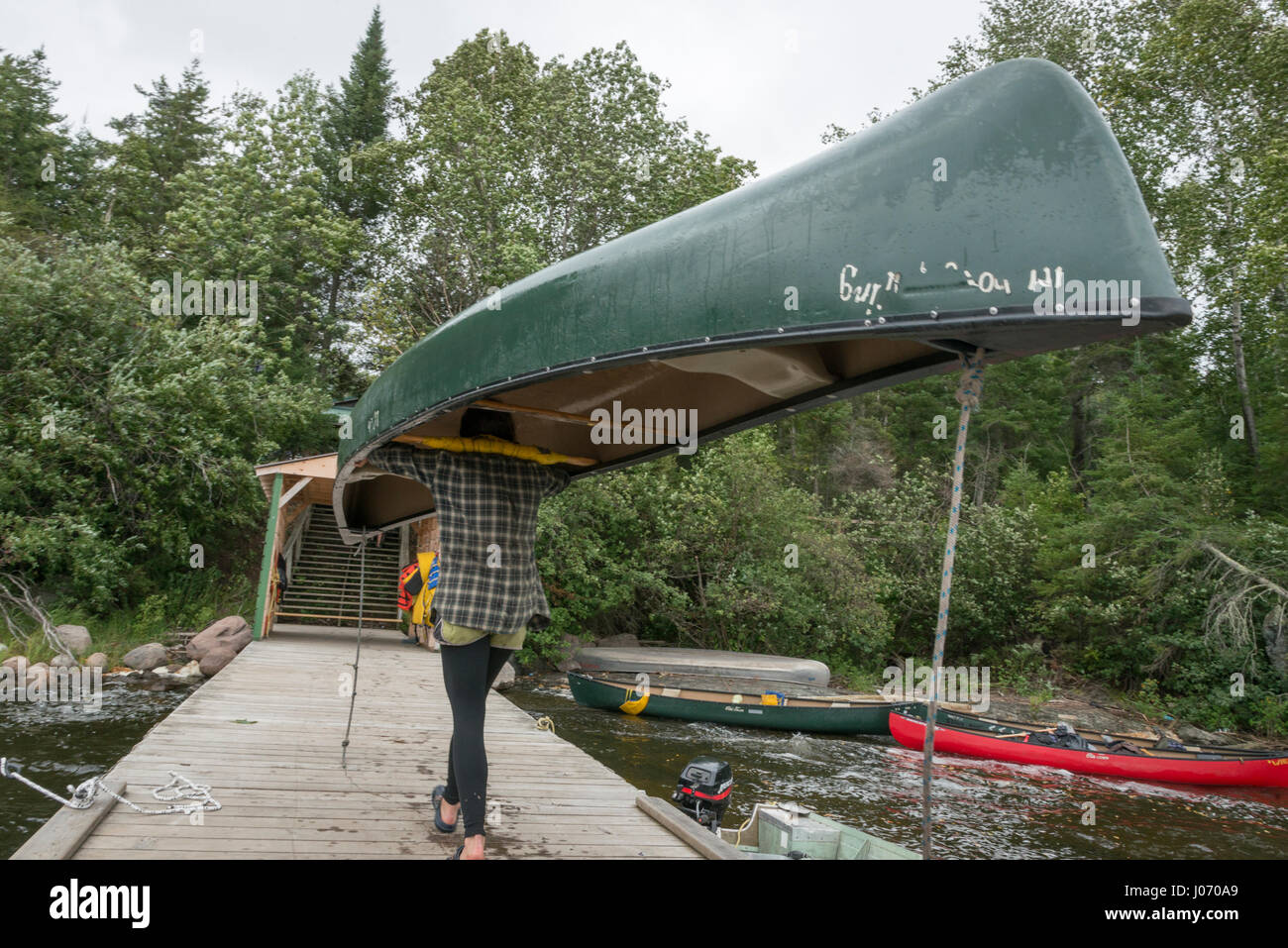 Teenage girl carrying a canoe on her head, BB Camp, Lake of The Woods