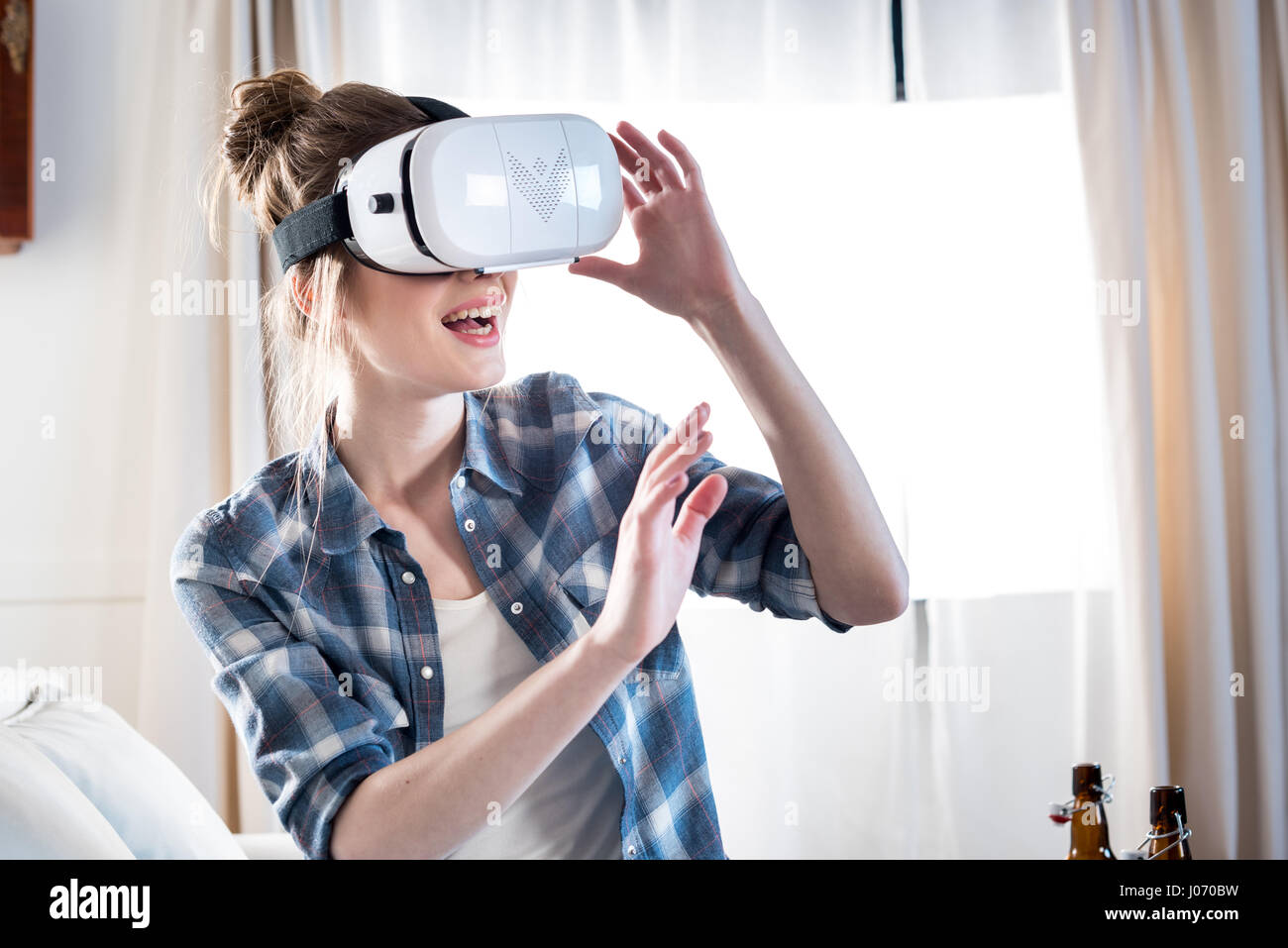 Young woman wearing virtual reality headset at home Stock Photo - Alamy