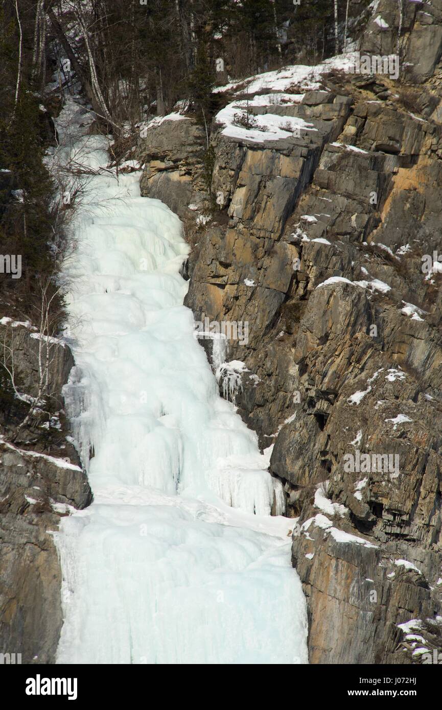 Frozen waterfall in winter time in the mountains Stock Photo