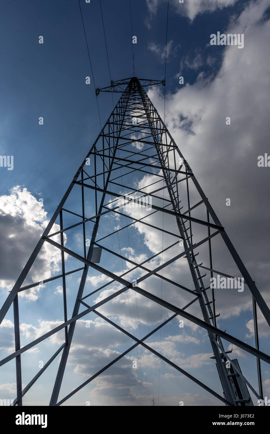 power line with sunny cloudy background Stock Photo - Alamy