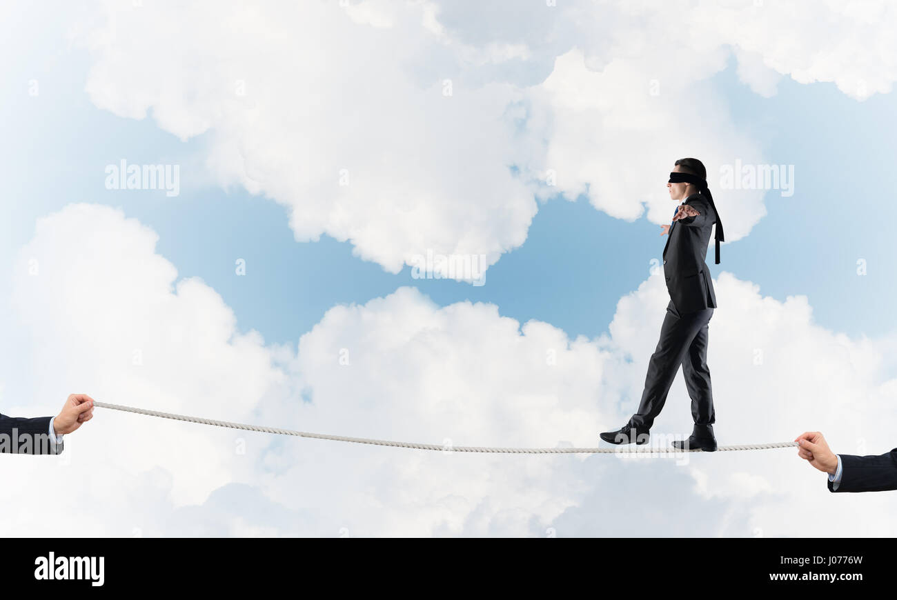 Business concept of risk support and assistance with man balancing on ...