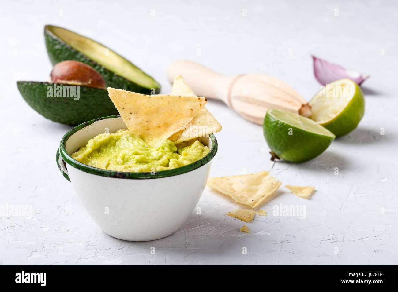 Mexican traditional guacamole in rustic white mug Stock Photo