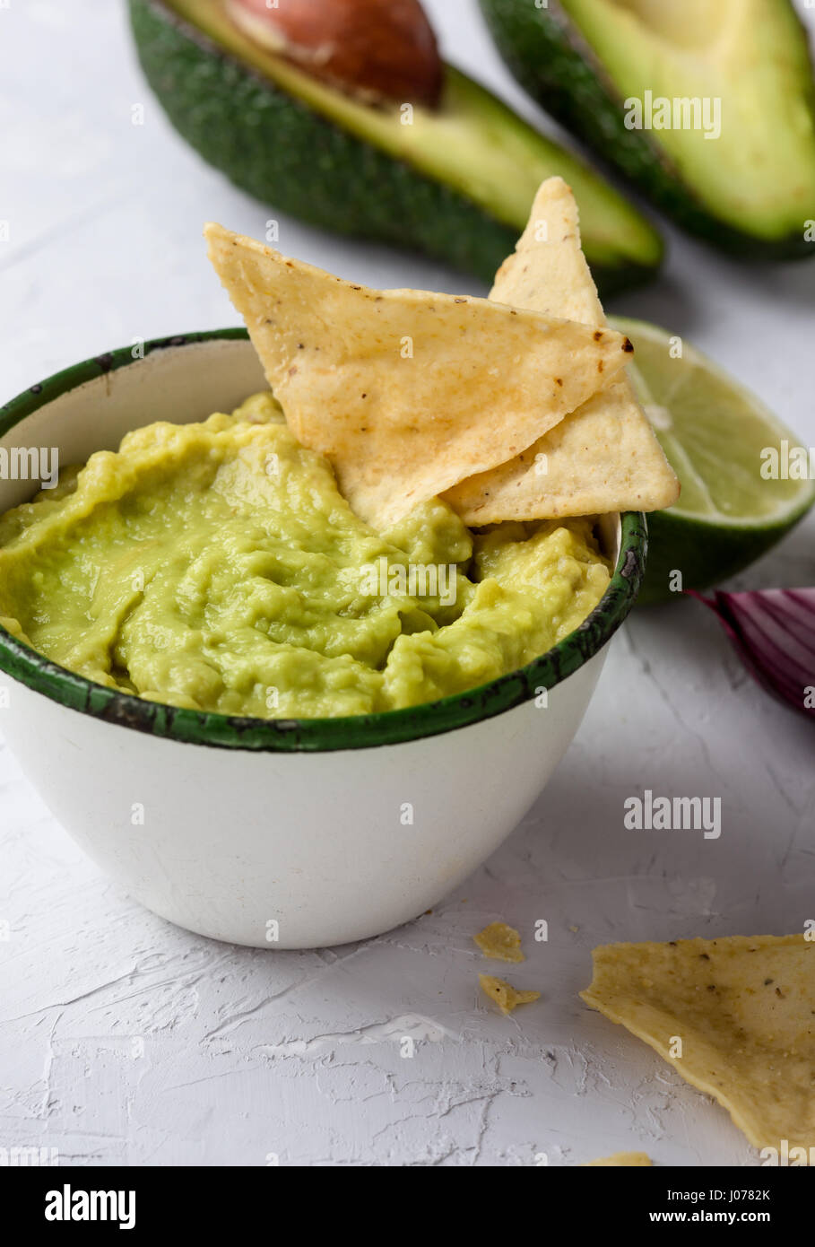 Mexican traditional guacamole in rustic white mug Stock Photo