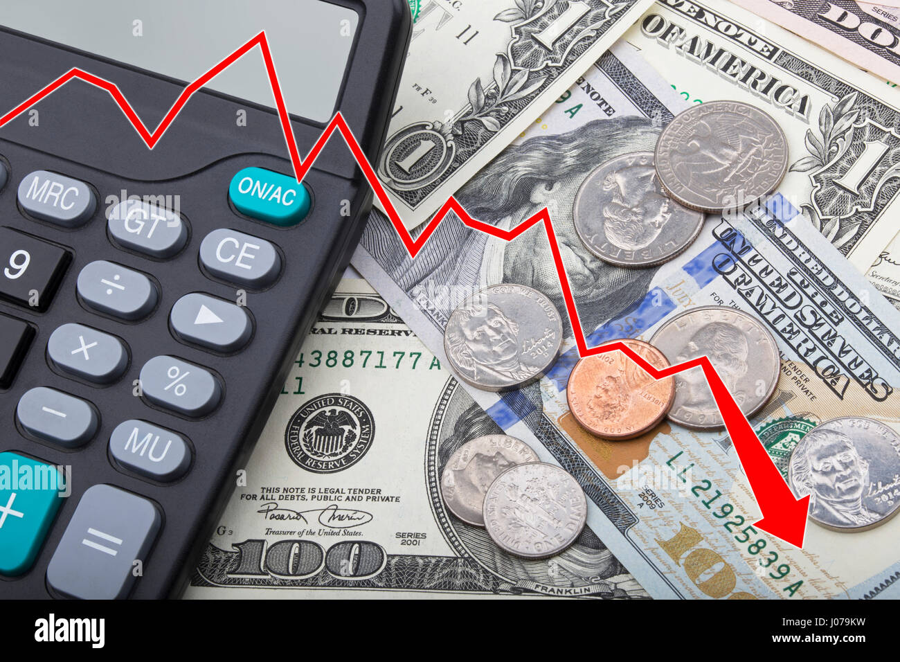Graph showing a decline in the economy of United States bank notes and coins with a calculator Stock Photo