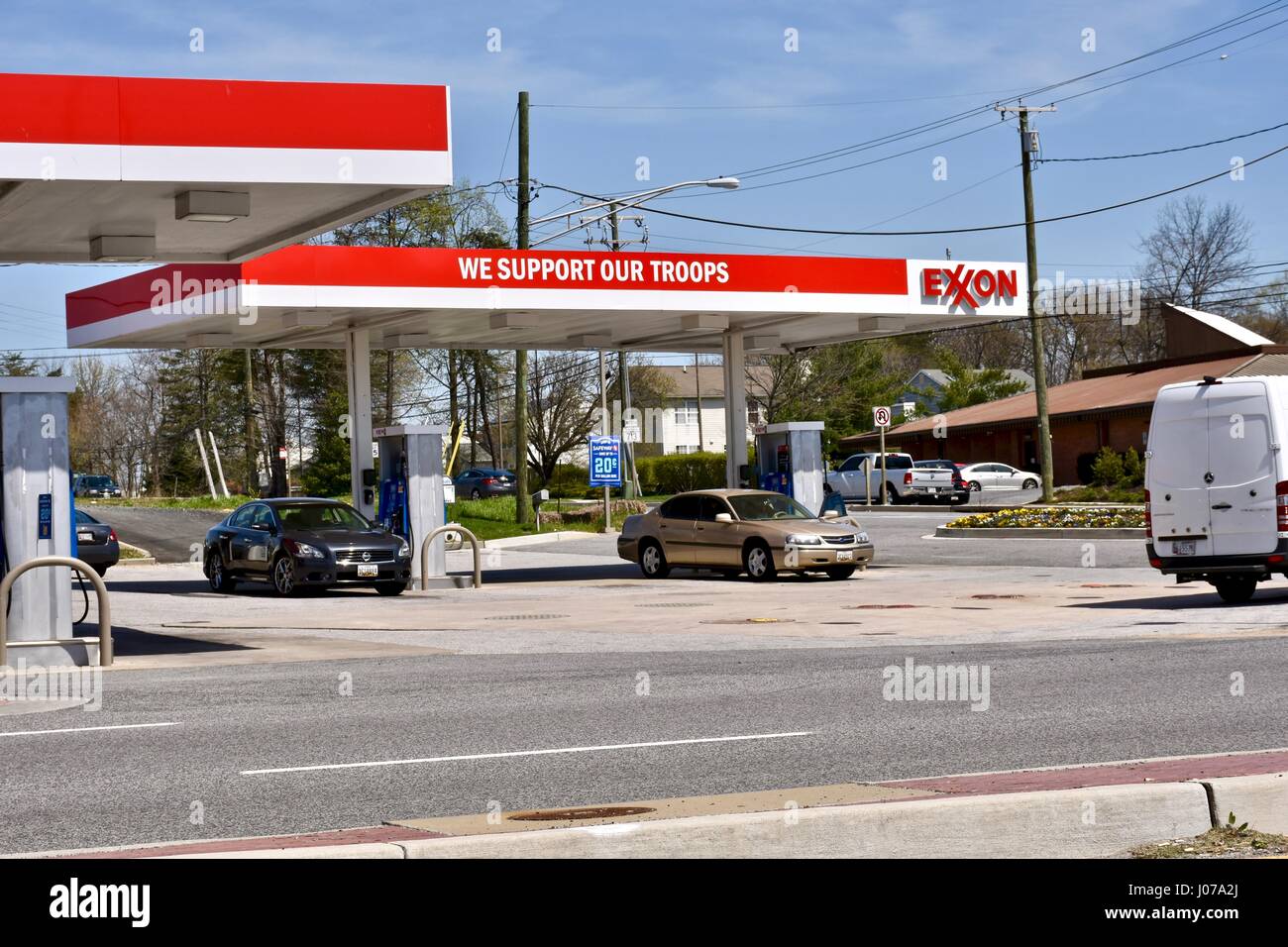 Exxon gas station with we support our troops sign Stock Photo