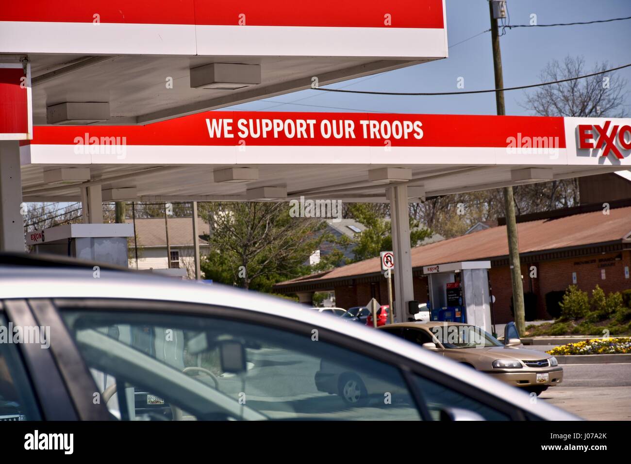 Exxon gas station with we support our troops sign Stock Photo