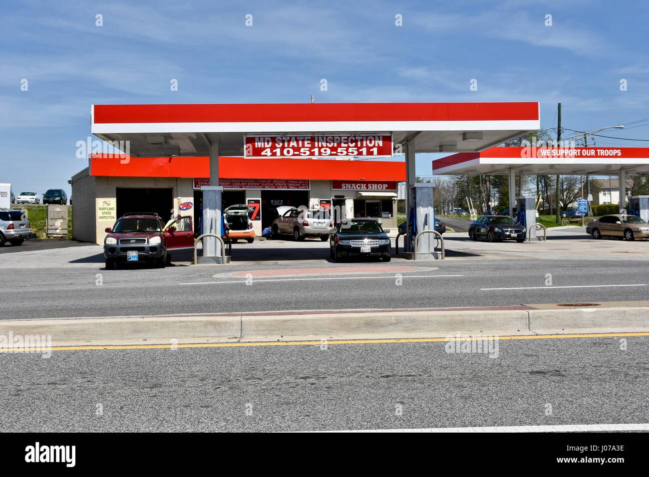 Exxon gas station with we support our troops sign Stock Photo