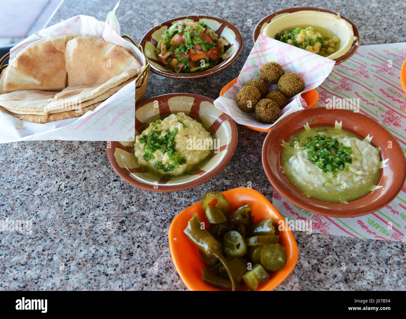 Traditional Jordanian breakfast- Hummus, Falafel and Pita bread served in a very popular restaurant in Aqaba, Jordan. Stock Photo