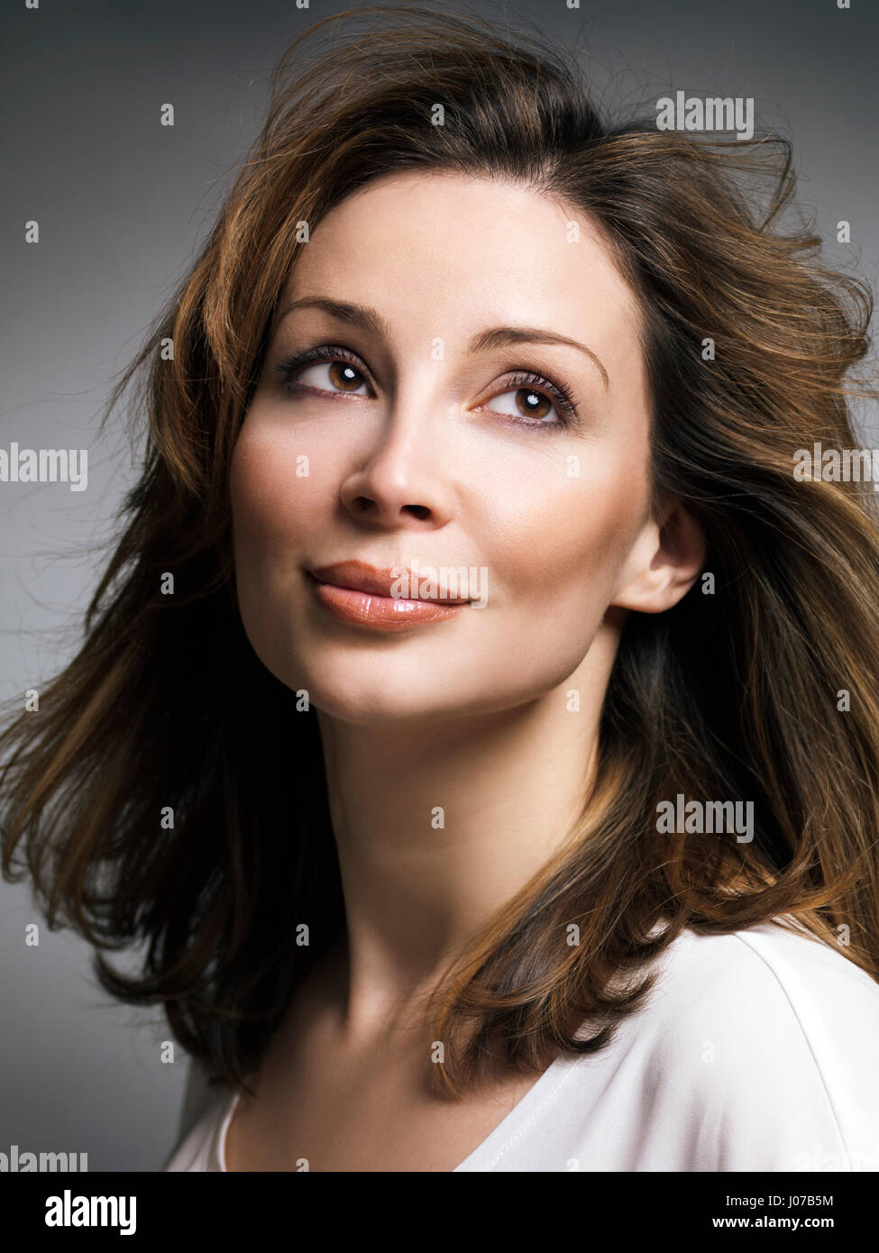 License available at MaximImages.com - Portrait of a beautiful smiling caucasian woman with brown hair with daydreaming expression in her thirties Stock Photo