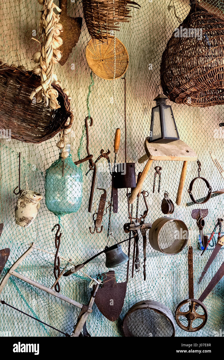 Ancient tools hanging on fishing net Stock Photo - Alamy