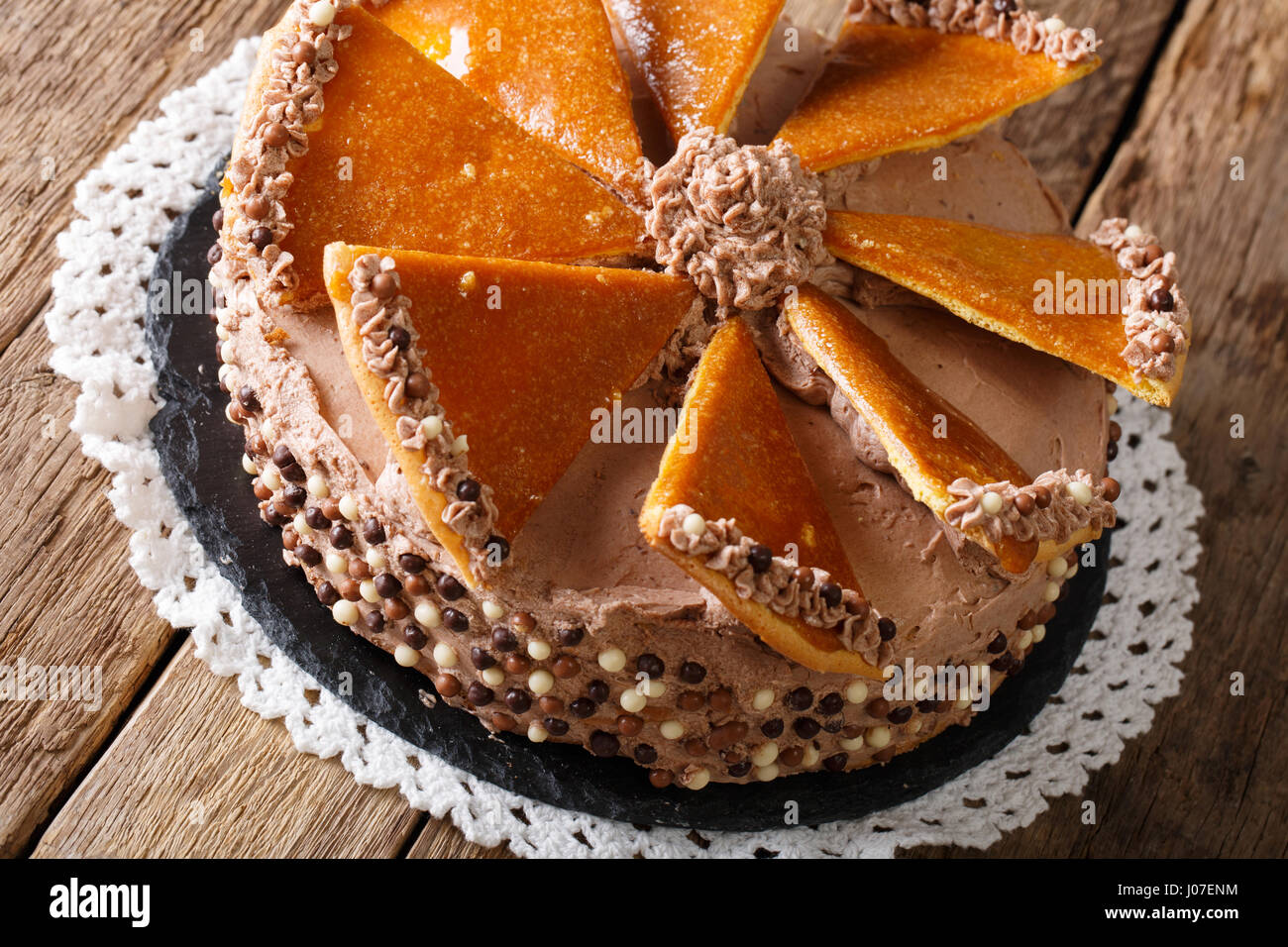 Hungarian Dobosh cake with caramel and butter cream close-up on a plate. Horizontal Stock Photo