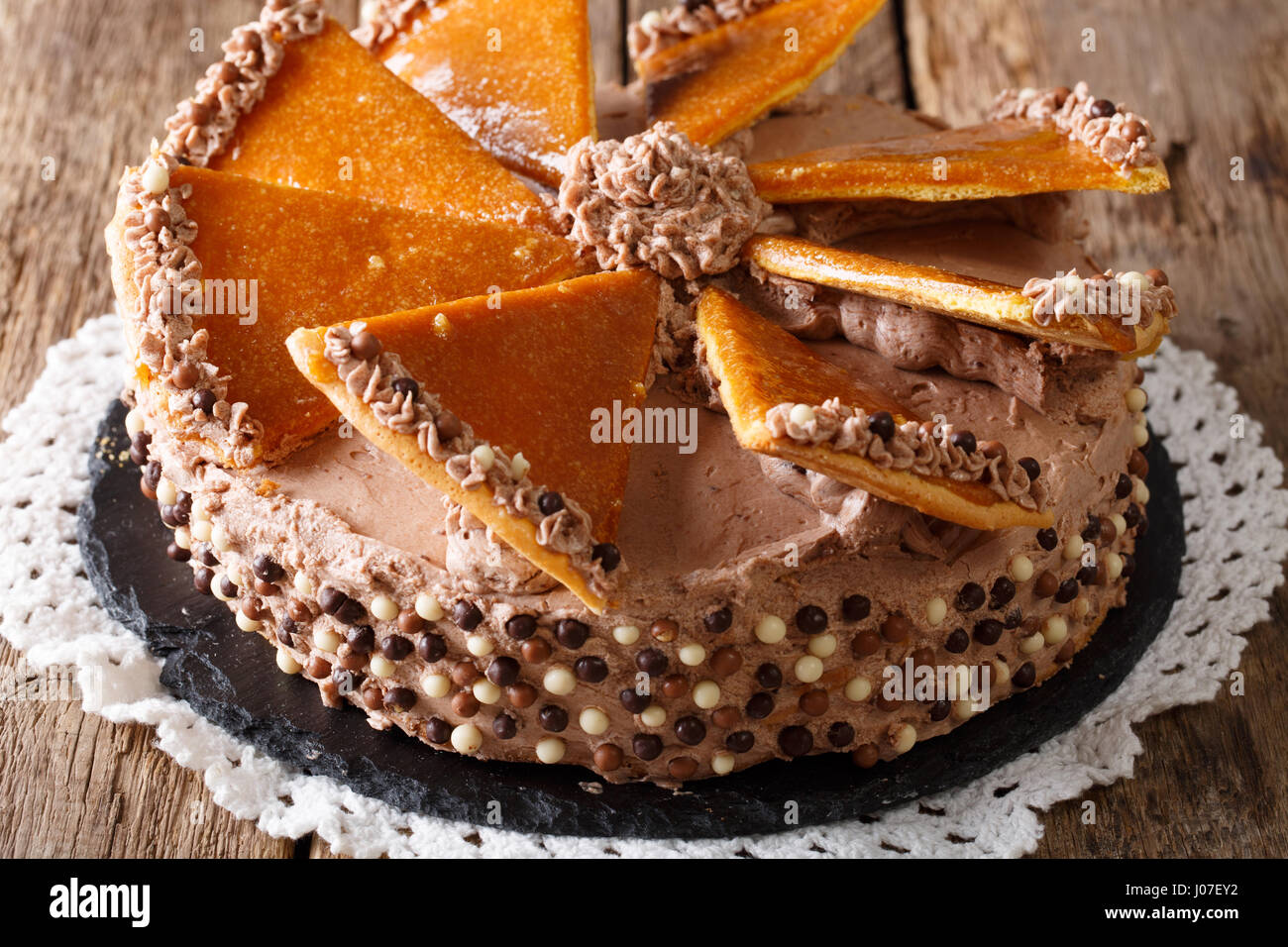 Tasty Hungarian Dobosh torte with caramel decoration close-up on a plate. horizontal Stock Photo
