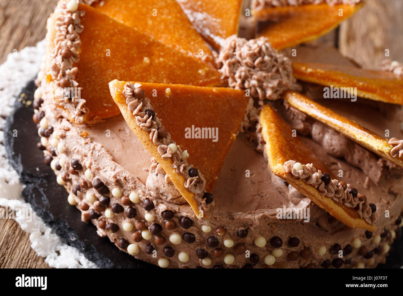 Traditional Hungarian Dobosh cake with caramel decoration macro on a plate. Horizontal Stock Photo