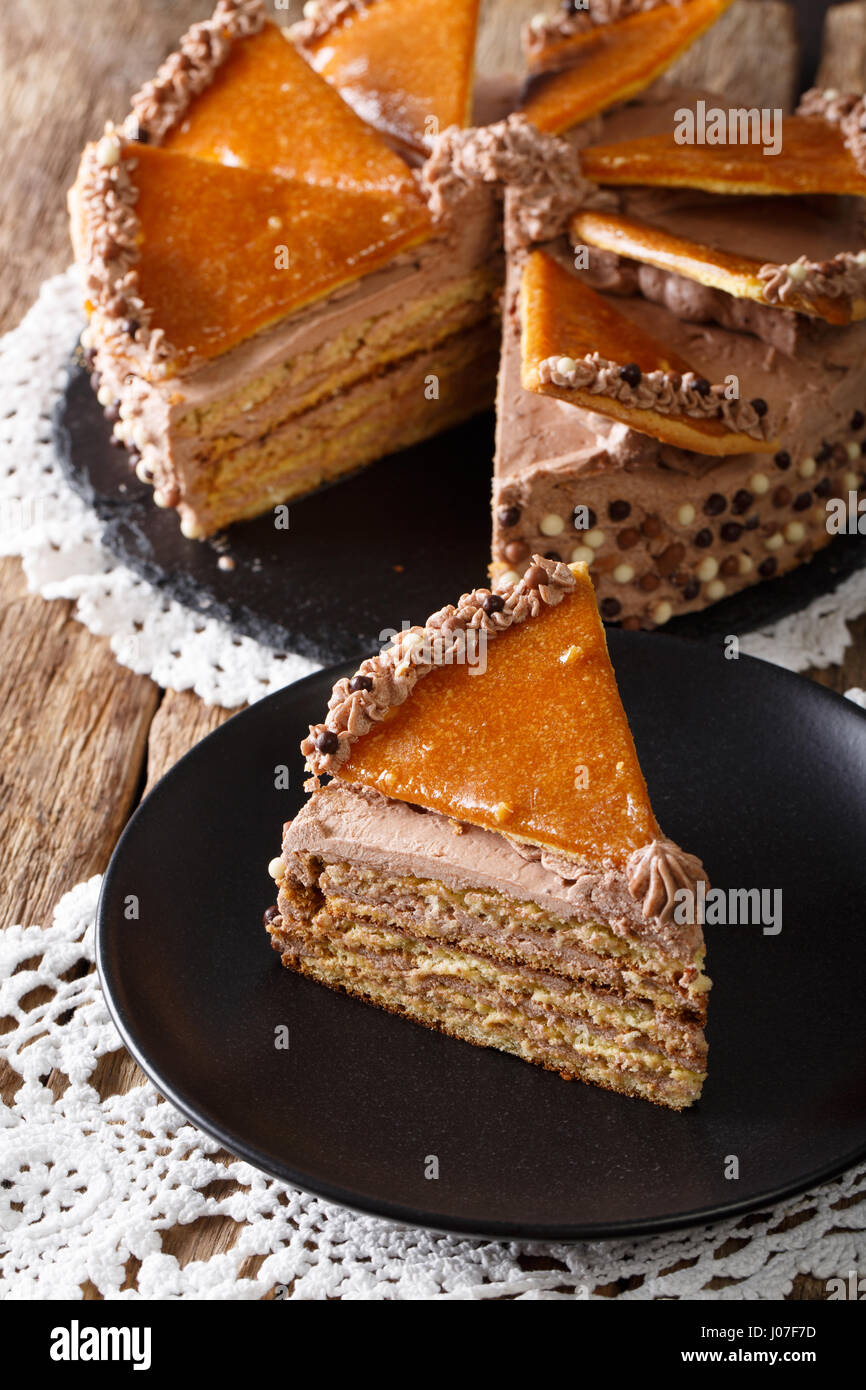 Delicatessen piece Hungarian Dobosh cake with caramel close-up on a plate. vertical Stock Photo