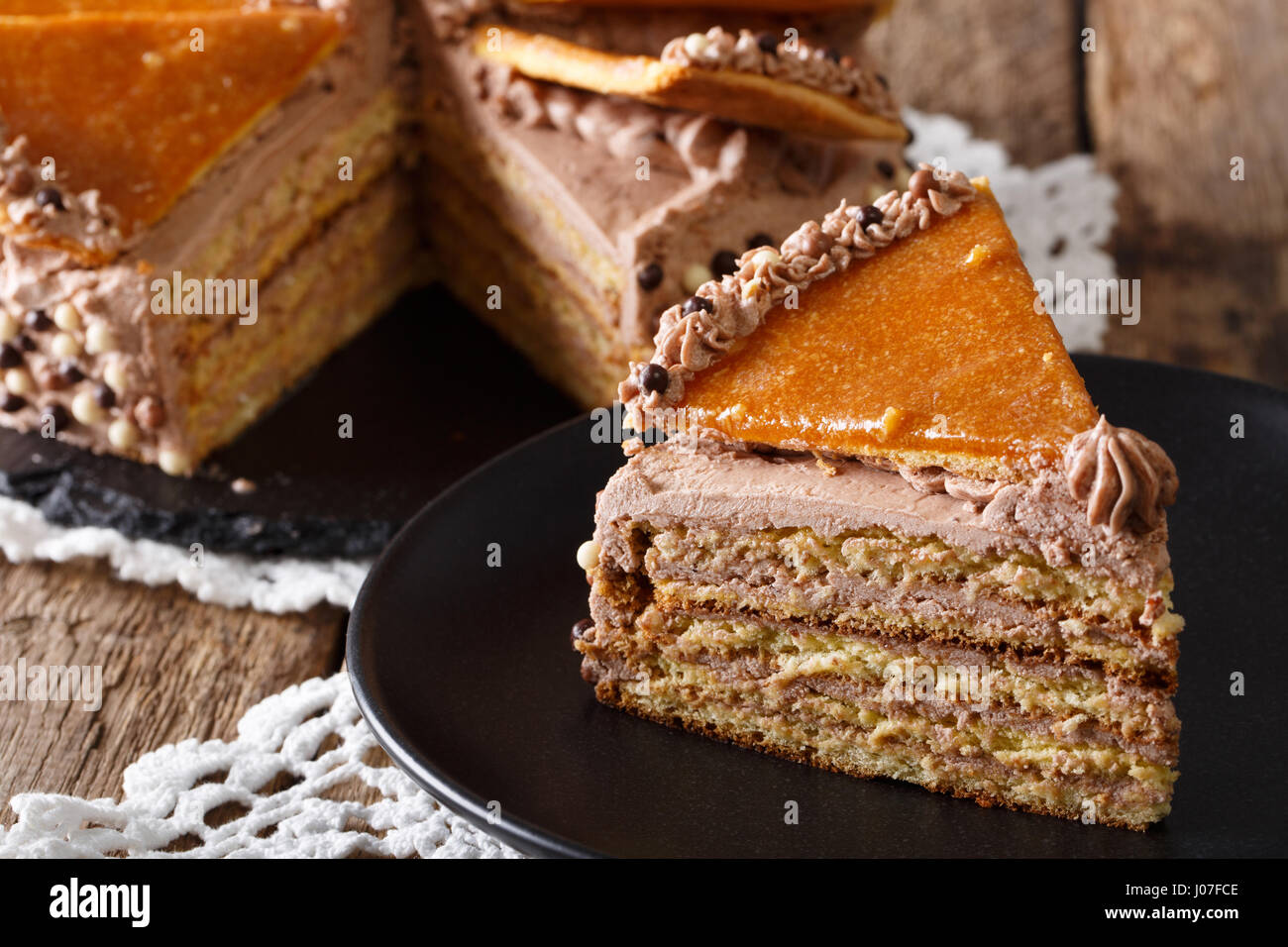 Delicious slice of Hungarian Dobosh cake with caramel close-up on a plate. horizontal Stock Photo