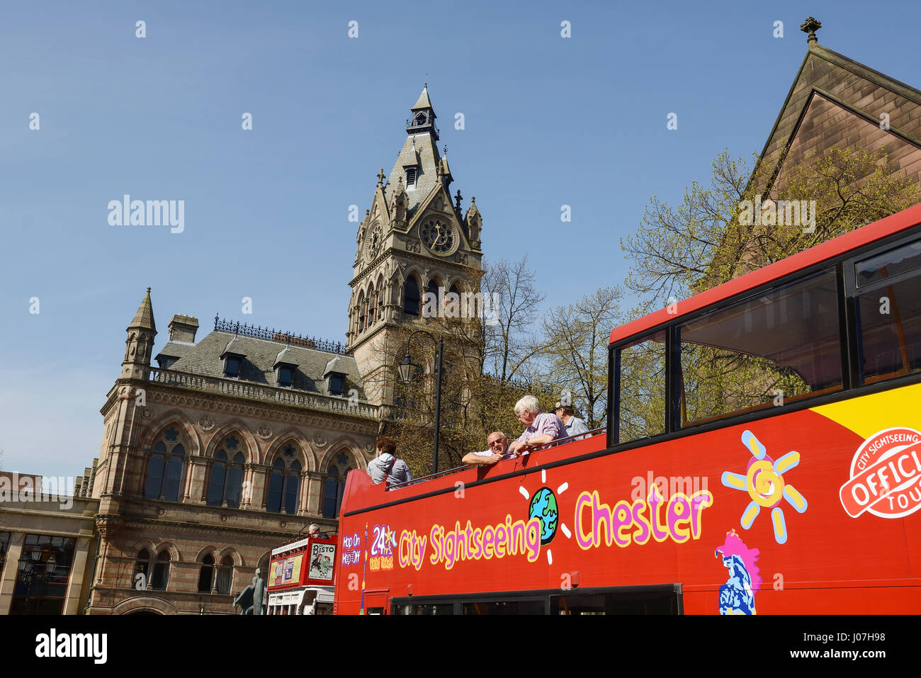 A sightseeing tour bus outside Chester Town Hall UK Stock Photo
