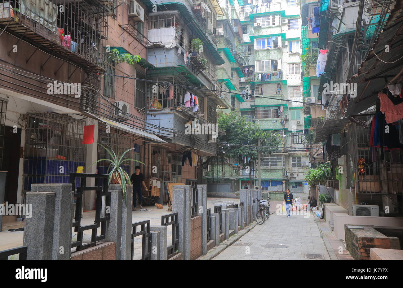 People walk on a small alley in residential area of Guangzhou China. Stock Photo