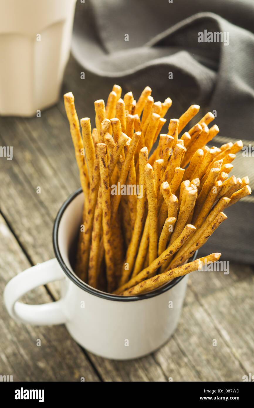 Salty pretzel sticks in white cup. Stock Photo